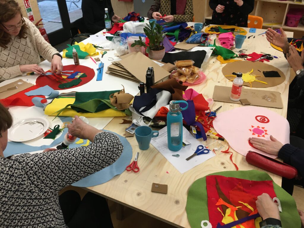 People working with felt sitting around a table