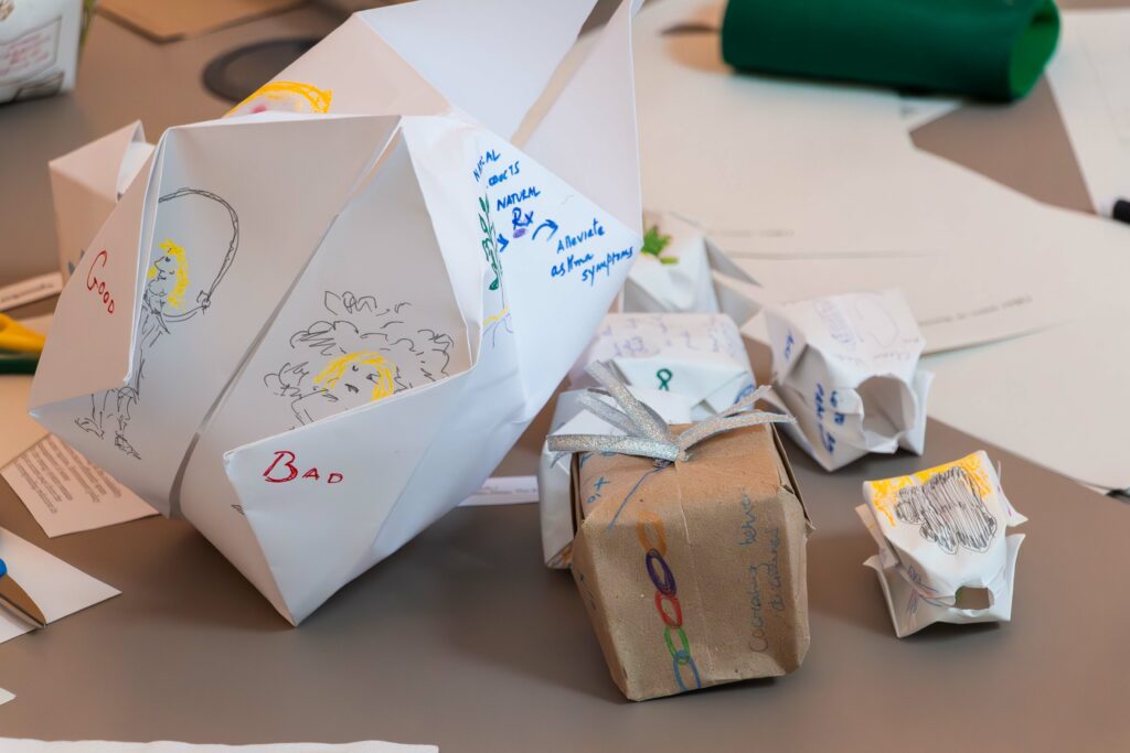 paper balloons on a table, one with good and bad written on it