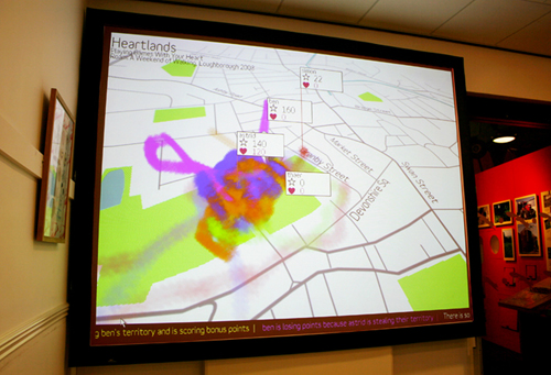 A screen with a map and coloured trails over the map and small squares of information including names and heart rate